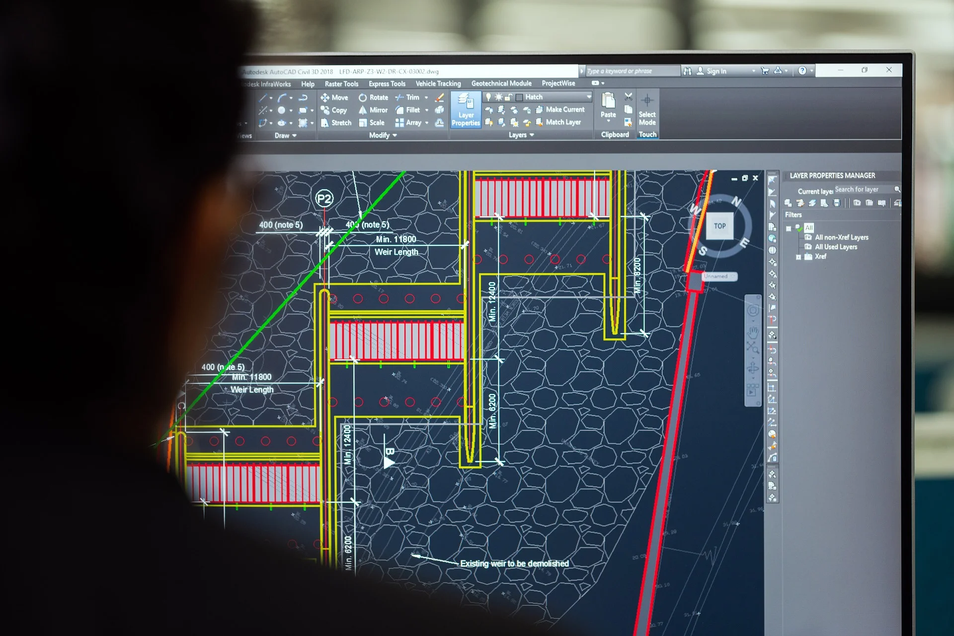 Architect working in AutoCAD on a large monitor